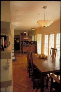 Dining table looking to kitchen in Garden Hills home in Atlanta Georgia designed by Steven Elmets Architecture